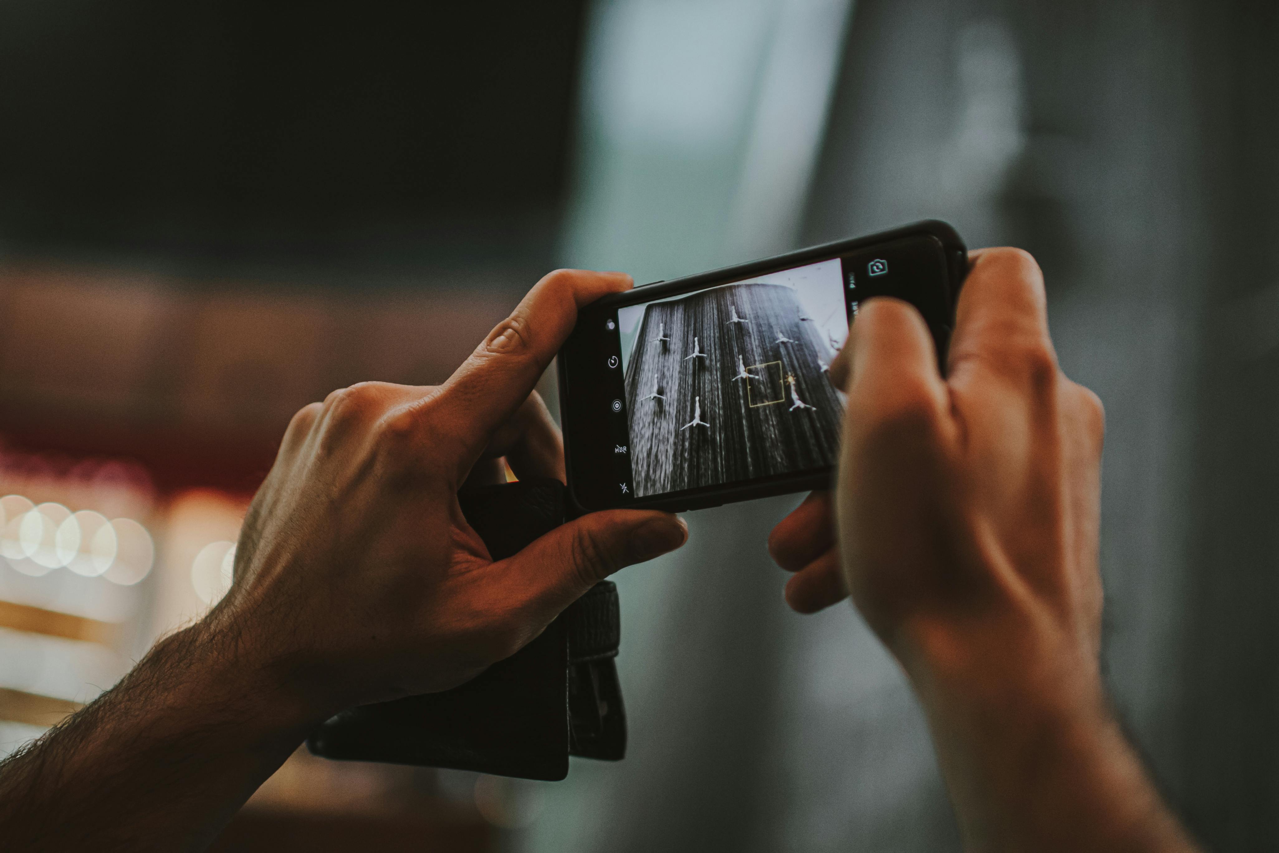 Hands holding smartphone taking photos